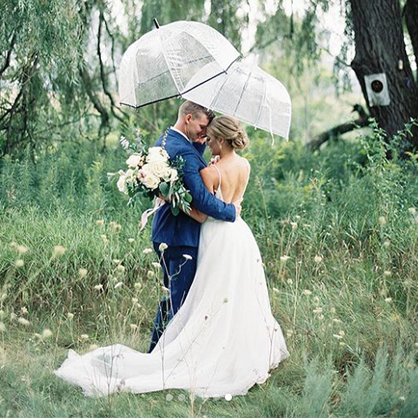 wedding packages romantic couple under an umbrella