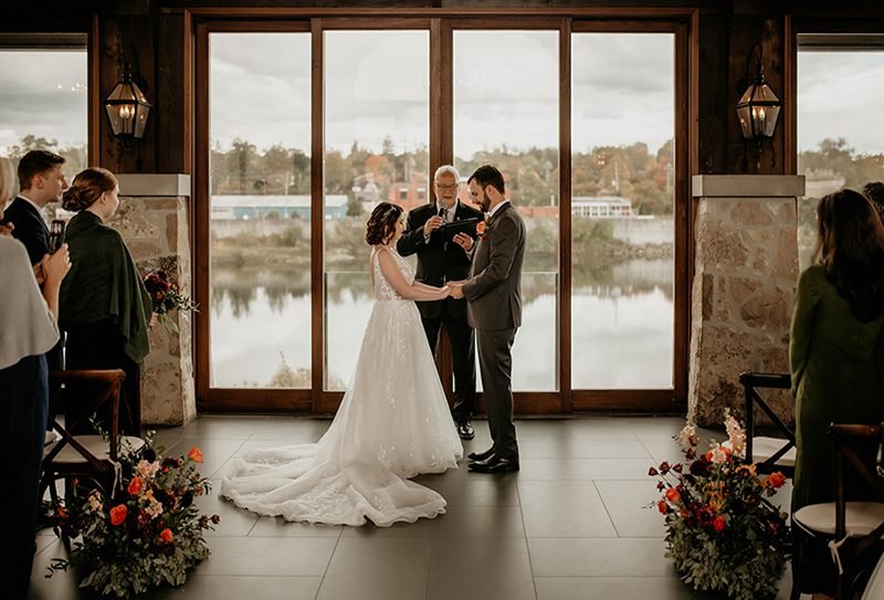 couple getting married at the cambridge mill with river view